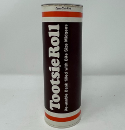 A photo of a cylindrical plastic bank from the 1980's simulating a giant Tootsie Roll